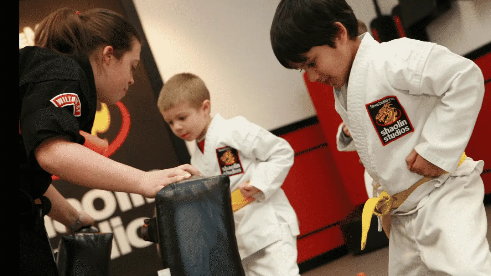 elementary students kicking a bag